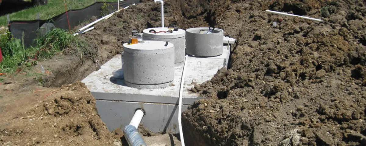Septic system repair and installation site with tank access ports in Ogden, UT